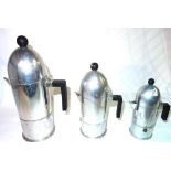 A 20th century steel three piece coffee set formed as a graduated set of Artillery shells,