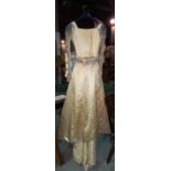 An Edwardian two piece wedding dress, comprising a cream silk long skirt with train,