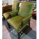 A pair of George III style mahogany open armchairs on block supports with green upholstery,