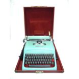 A 20th century 'Olivetti' baby blue typewriter, cased.