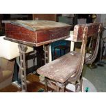 An early 20th century oak school desk with cast iron base, 56cm wide.