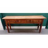 An early 19th century French waxed pine three drawer dresser base on tapering square supports,