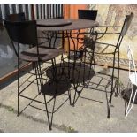 A 20th century black painted wrought iron high bar table with four matching chairs,