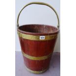 A George III brass bound coopered mahogany peat bucket, with swing-over handle,