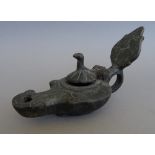 An unusual bronze oil lamp, the hinged lid in the form of a bird, 14cm wide.