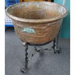 A Victorian copper copper on a black painted wrought iron stand (70cm diameter),