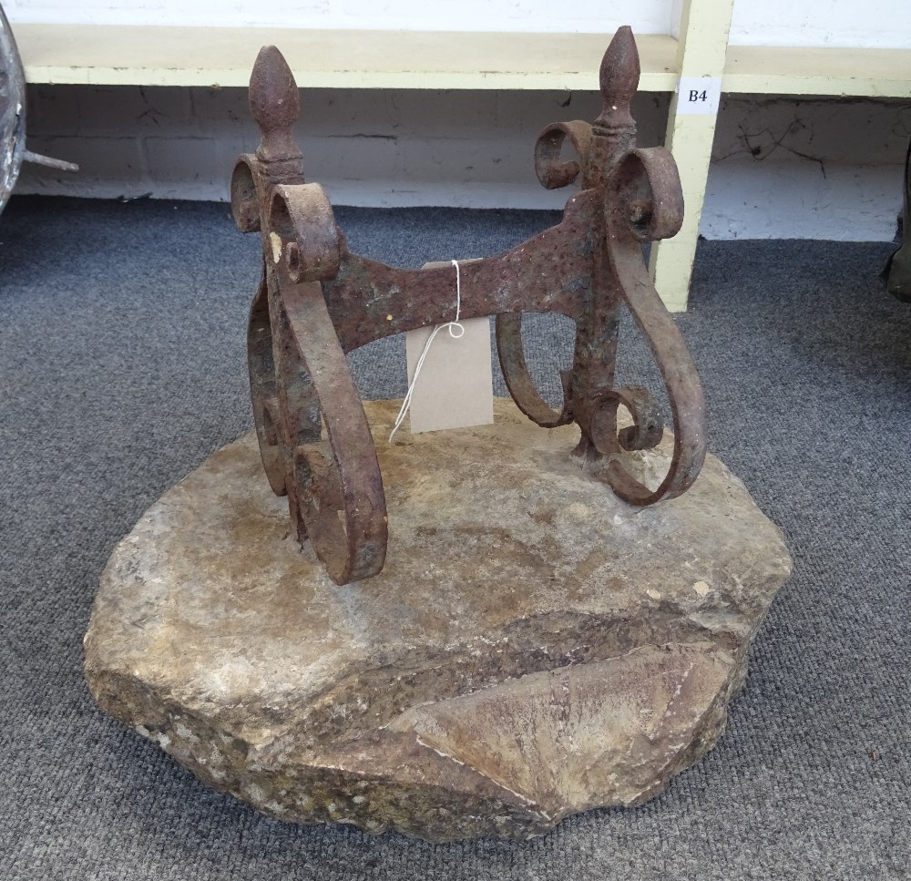 An early 19th century wrought iron boot scraper, on stone base, 45cm wide.
