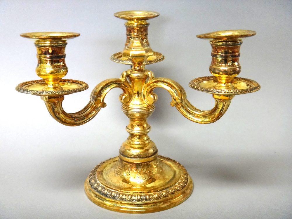 A French silver gilt three light table candelabrum,