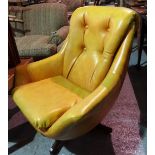 A 20th century "Egg" style armchair with faux leather upholstery.