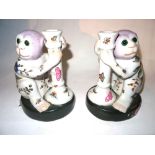 A pair of 20th century Asian candlesticks formed as monkeys, 22cm high, (2).