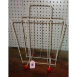 A 1950s Atomic Sputnik magazine rack, white steel frame and red wooden ball feet, 30cm wide.