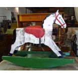 A 20th century wooden rocking horse, 70cm wide x 79cm high.