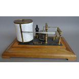 An oak cased aneroid barograph by Negretti and Zambra, on a plinth and four feet, 34.5cm wide.