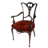 An Edwardian mahogany salon elbow chair,