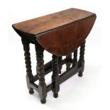 A 17th century style oak gateleg table,