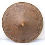 A large basketwork coolie type hat, prob