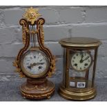 A gilt brass cased, oval four glass mantel clock with enamel dial and two train movement, 22cm high,