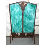 A French Art Nouveau wrought iron fire screen with inset faux hardstone panels of foliate