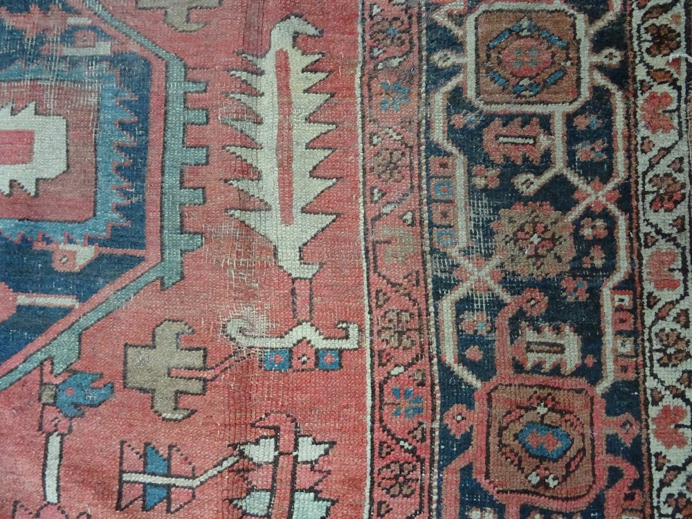 An Heriz carpet, Persian, the madder field with a bold angular pole medallion, ivory spandrels, - Image 6 of 23