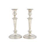 A pair of silver table candlesticks, each with a tapered stem, gadrooned rims,