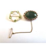 A gold, peridot and seed pearl brooch, of shaped circular form,