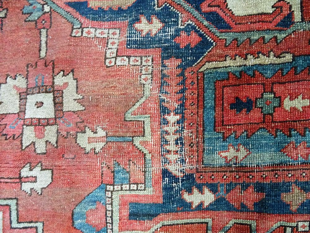 An Heriz carpet, Persian, the madder field with a bold angular pole medallion, ivory spandrels, - Image 10 of 23