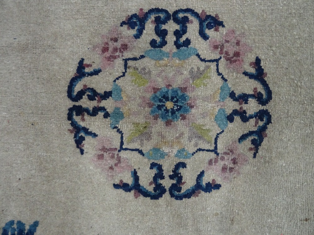 A Chinese carpet, the ivory field with a central roundel, floral sprays, - Image 4 of 5