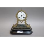A French brass mantel clock with enamel dial detailed 'Hausburg Paris', 18cm high,