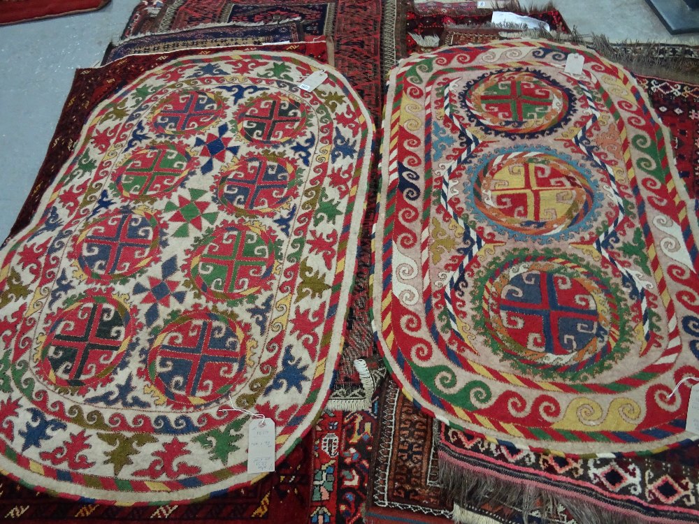 An Uzbek felt saddle cloth, the ivory field with two column of four cross roundels, - Image 2 of 6