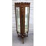 A mid-20th century bronze display cabinet, with pair of bevelled glass doors,