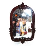 A Victorian mahogany wall mirror with acanthus moulding and carved three lions crest.