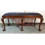 A George III style mahogany rectangular footstool on ball and claw supports, 113cm wide x 55cm high.