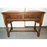 A 20th century oak dresser base with two drawers on turned block supports,