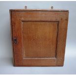 An 18th century and later oak and pine hanging spice cupboard,