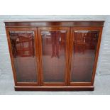 A Victorian mahogany floor standing bookcase, with three bevelled glazed doors, on plinth base,