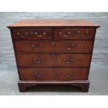 A George III and later figured walnut chest with two short and three long graduated drawers on