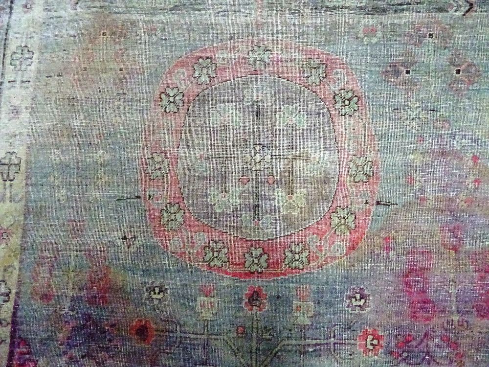 A Khotan carpet, ,the faded purple field with three bold roundels, - Image 5 of 7