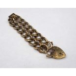 A 9ct gold faceted curb link bracelet, on a 9ct gold heart shaped padlock clasp, weight 43.7 gms.