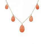 A gold and coral necklace, the front mounted with five graduated drop shaped pendant coral beads,