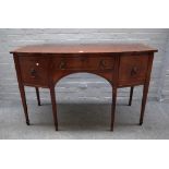 A late George III inlaid mahogany bowfront sideboard, with three frieze drawers,