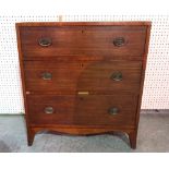 An Edwardian mahogany chest of three long drawers on splayed bracket supports,