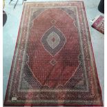 A 20th century red Turkish rug, 195cm wide x 296cm high.