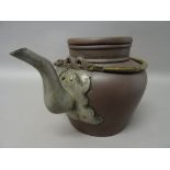 A Chinese Yixing stoneware teapot and cover, circa 1900, with metal spout, impressed marks, 16cm.