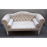 A Regency style window seat/sofa with humpback and rollover arms on white painted baluster turned