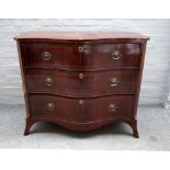 A late George III inlaid mahogany serpentine chest of three long graduated drawers,