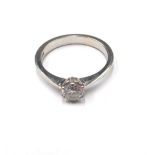 An 18ct white gold and diamond single stone ring, claw set with a circular cut diamond,