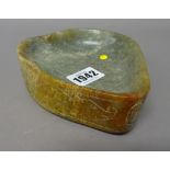 A Chinese jade archaistic brushwasher, of shaped triangular form,