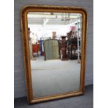 A 19th century gilt framed rounded rectangular overmantel mirror,
