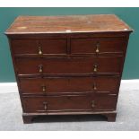 An early 18th century oak chest of two short and three long graduated drawers, on bracket feet,