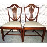 A set of six George III mahogany shield back dining chairs on square tapering supports, (6).
